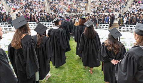 Occidental College graduating seniors in formation in the Greek Bowl, facing away from the camera