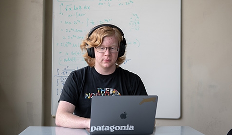 An Occidental College student studies on campus
