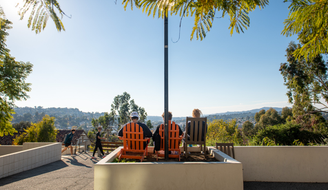 Occidental students sit on chairs outside a residence hall