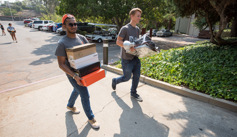 Occidental students bring boxes into the residence hall on move in day