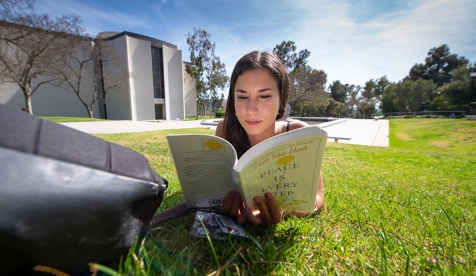 student reading on campus