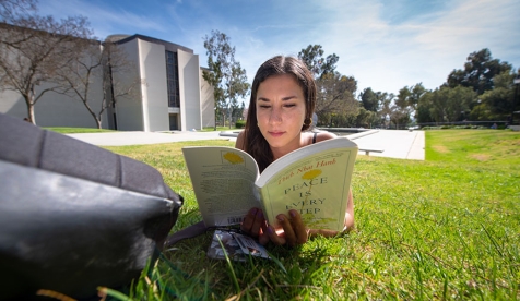 student reading on campus