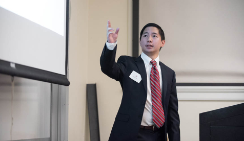 Economics student presenting his research