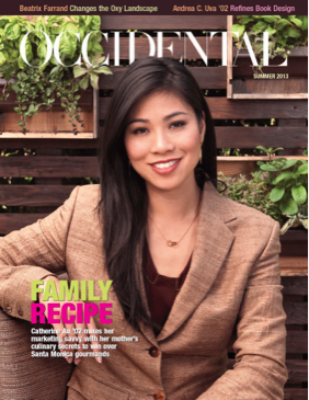 A woman in a brown suit jacket sits smiling on a bench. Cove