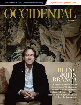 A man sits pensively on a couch. Cover story: Being John Bra