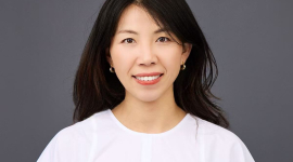 Woman in front of gray background