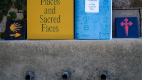 Colorful photo of two books sitting on a cement ledge. 