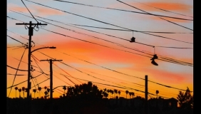 a view of los angeles and electrical poles at sunset