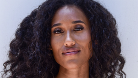 Headshot of Anna Tubbs with long curly dark hair