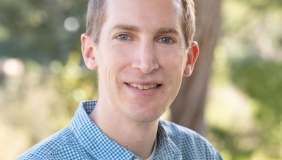 Dr. Brandon Taylor in front of a tree