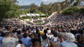 A crowd full of people sititng in the Remsen Bird Hillside Theater at Commencement in 2025