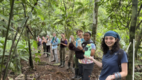 Several people in front of trees