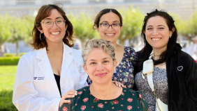 Dafna Erana Hernandez in a white coat with three women