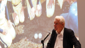 Image of Robert Whiting giving a presentation at a podium.