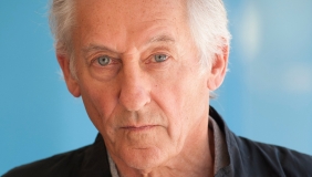medium color portrait of Ed Ruscha wearing a button up shirt &amp; jacket, looking directly to camera
