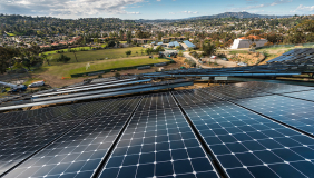 A slanting view of Occidental's solar array with campus in the far background