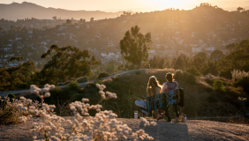 two Occidental students in a late afternoon sun-drenched scene on top of Fiji Hill at sunset
