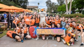 Oxy students with Oswald holding a Homecoming banner