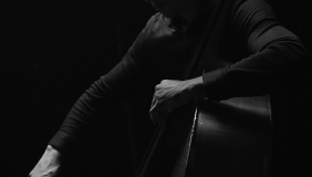 black and white photo of a man playing an upright bass 