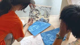 color photo of two people making cyanotypes