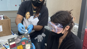 artist displaying finished mosaic