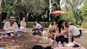 wide color photo of people doing crafts in a garden