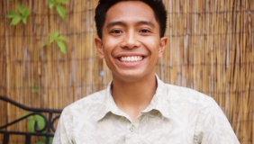 Man in white shirt in front of brown background