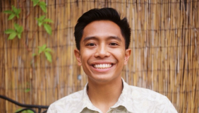 Man in white shirt in front of brown background