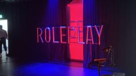 An empty stage with the words "roleplay" projected