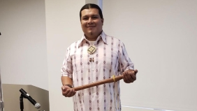 Lazaro stands in a patterned shirt 