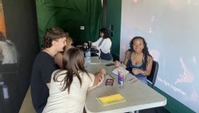 color image of four people creating books at an arts workshop