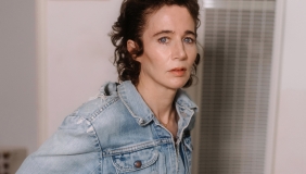 medium color portrait of Miranda July wearing a jean jacket, turned to camera right and looking direct to camera