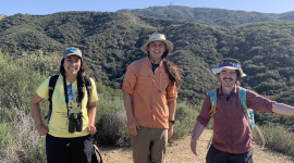 Three hikers on a hillside