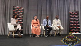 Awardees at the ceremony, four people seated on a stage