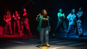 students in hip-hop clothing stand in a formation on the Keck Theater stage