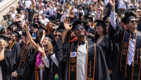 A scene on commencement day with a big crowd of happy graduates