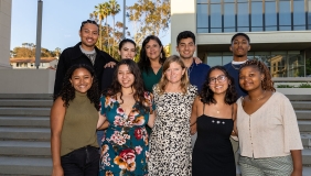 8 Obama Scholars pose with Maya Soetero-Ng on the steps of AGC