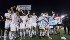 Oxy's men's soccer team celebrating on the field