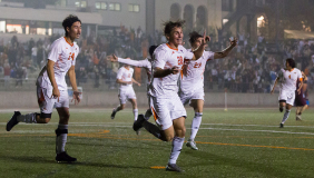 Occidental College men's soccer players in white jerseys out on the playing field