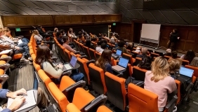 Choi Auditorium filled with people and a guest speaker up front