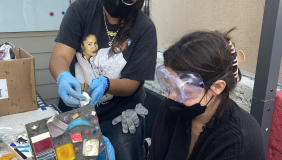 color image of a workshop participant making a mosaic