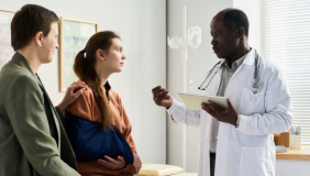 Photo including a doctor and two patients
