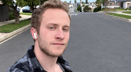 Occidental Student posing for photo in residential neighborhood