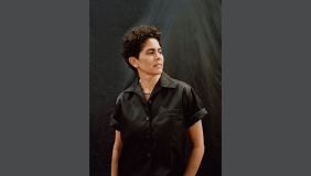 Portrait of Julie Mehretu with a black top in semi-profile