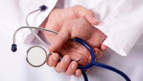 a doctor holding a stethoscope in his hands