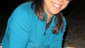 Woman with glasses holding small animal