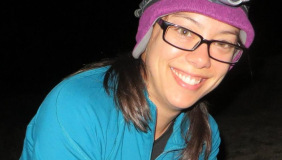 Woman with glasses holding small animal