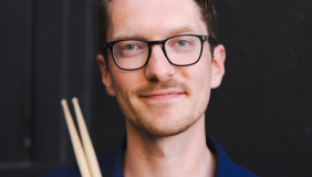 Kevin van den Elzen headshot with drumsticks