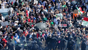 A gathering of people at a protest. The crowd is dense. 