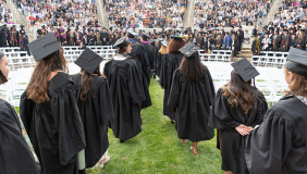 Occidental College graduating seniors in formation in the Greek Bowl, facing away from the camera